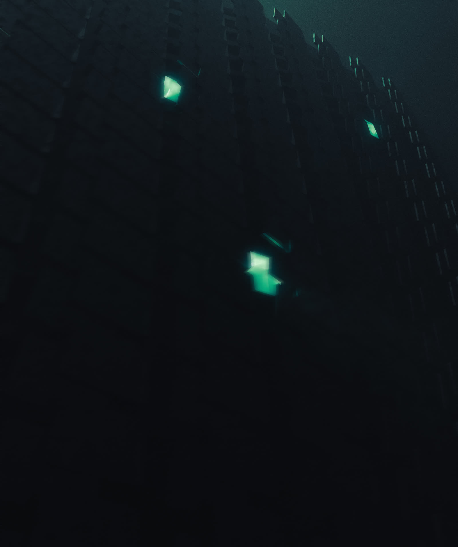 A dark facade with scattered glowing green window panels