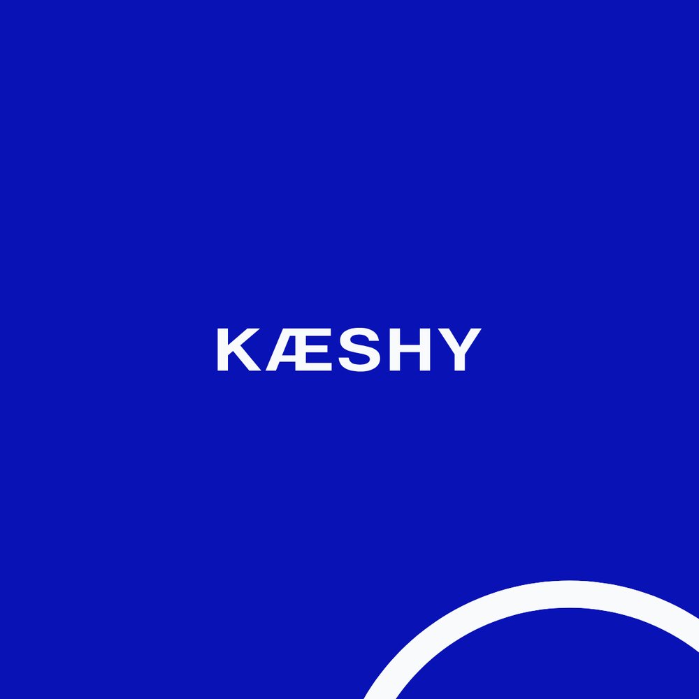 Kæshy wordmark in white on a Klein blue background, with a white arc graphic in the corner